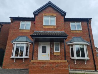 Detached home finished with new anthracite fascias, bargeboards and guttering