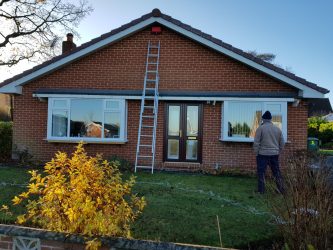Bungalow fascia and soffit replacement underway with access ladders in place