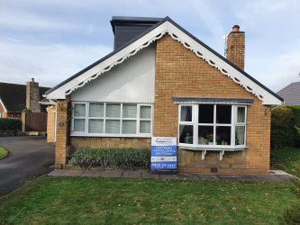 Bungalow with decorative white scalloped bargeboards, fascias and soffits