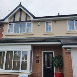 New white fascias and soffits with black guttering on a modern detached home