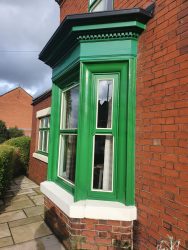 Period bay window with freshly painted timber cornice and sill detailing