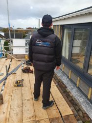 Rooftop Systems installer replacing fascias and soffits from scaffolding