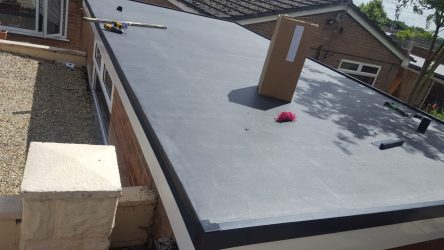 Bungalow flat roof replacement with grey EPDM rubber membrane and anthracite edge trims