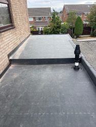 Two-level EPDM rubber flat roof extension with neatly sealed boiler flue outlet