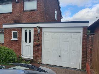Garage and porch flat roof with new white uPVC fascias, guttering and black edge trim