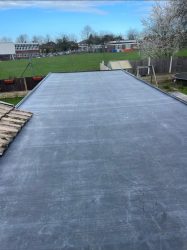 Large flat rubber roof installation on a rear extension with neat edge detailing