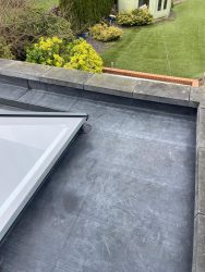 Parapet flat roof with EPDM rubber membrane and flush glass skylight lantern