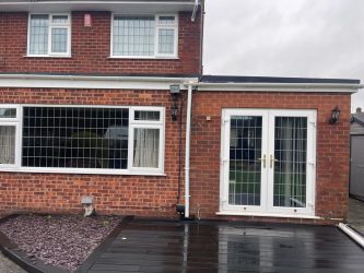 Rear extension flat rubber roof above French doors with new white guttering