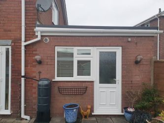 Single storey rear extension with new flat rubber roof, white uPVC fascias and guttering